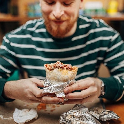 Man enjoying a burrito.