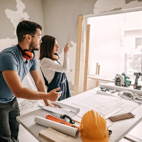 Young couple working together on a home remodel pr
