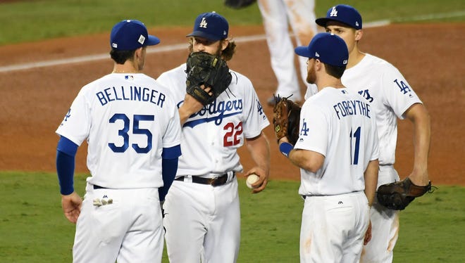 Clayton Kershaw, center, will likely be the most valuable Dodger in fantasy baseball, but first baseman Cody Bellinger and shortstop Corey Seager, far right, aren't far behind.