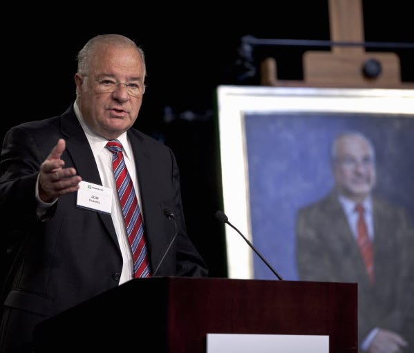 Online brokerage TD Ameritrade founder Joe Ricketts speaks Tuesday, Feb. 14, 2012, during a ceremonial unveiling of his portrait. Rickets abruptly shut DNAInfo and the Gothamist web sites Thursday.