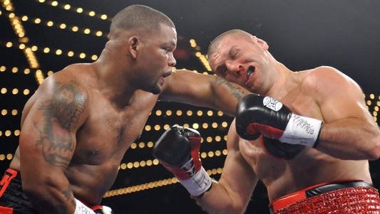Mike Perez, left, lands a hard left hook on the head of Magomed Abdusalamov during their heavyweight bout in November 2013. Abdusalamov underwent brain surgery after the fight to remove a blood clot from his brain.