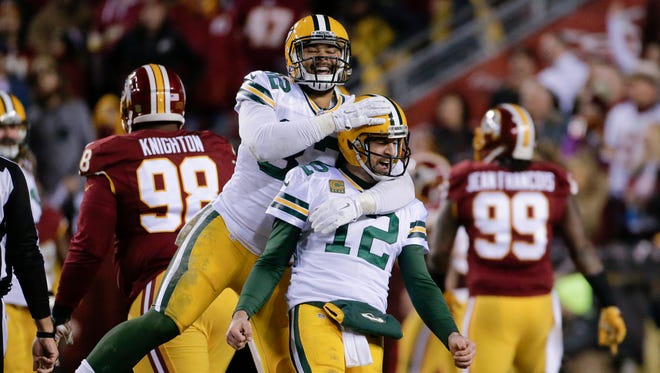 Green Bay Packers tight end Richard Rodgers (82) celebrates Sunday with quarterback Aaron Rodgers (12) after wide receiver Davante Adams caught a touchdown pass during the first half of an NFL wild-card playoff football game against the Washington Redskins in Landover, Md. (
