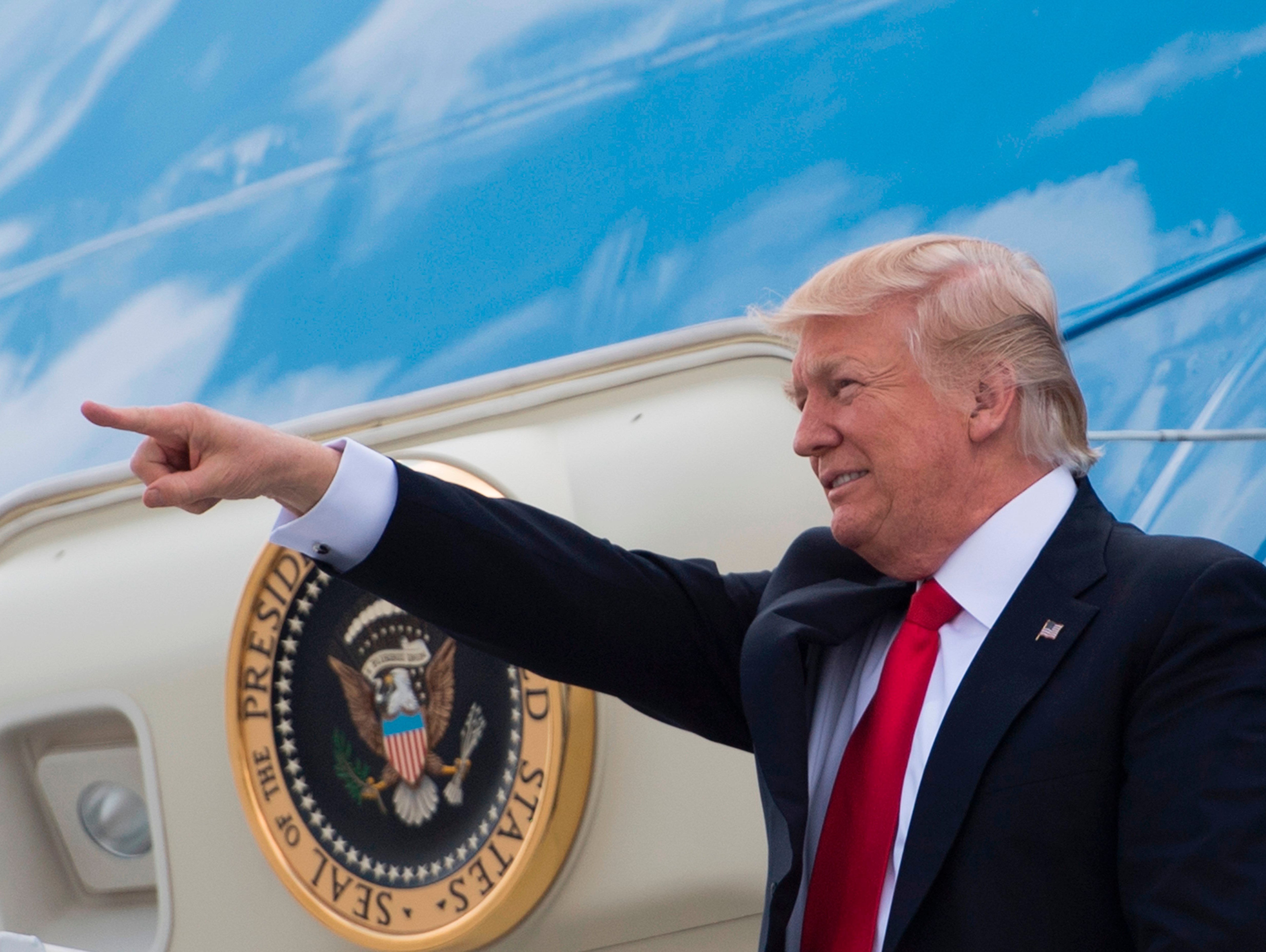 President Trump points to supporters as he walks off Air Force One in Atlanta on April 28, 2017.
