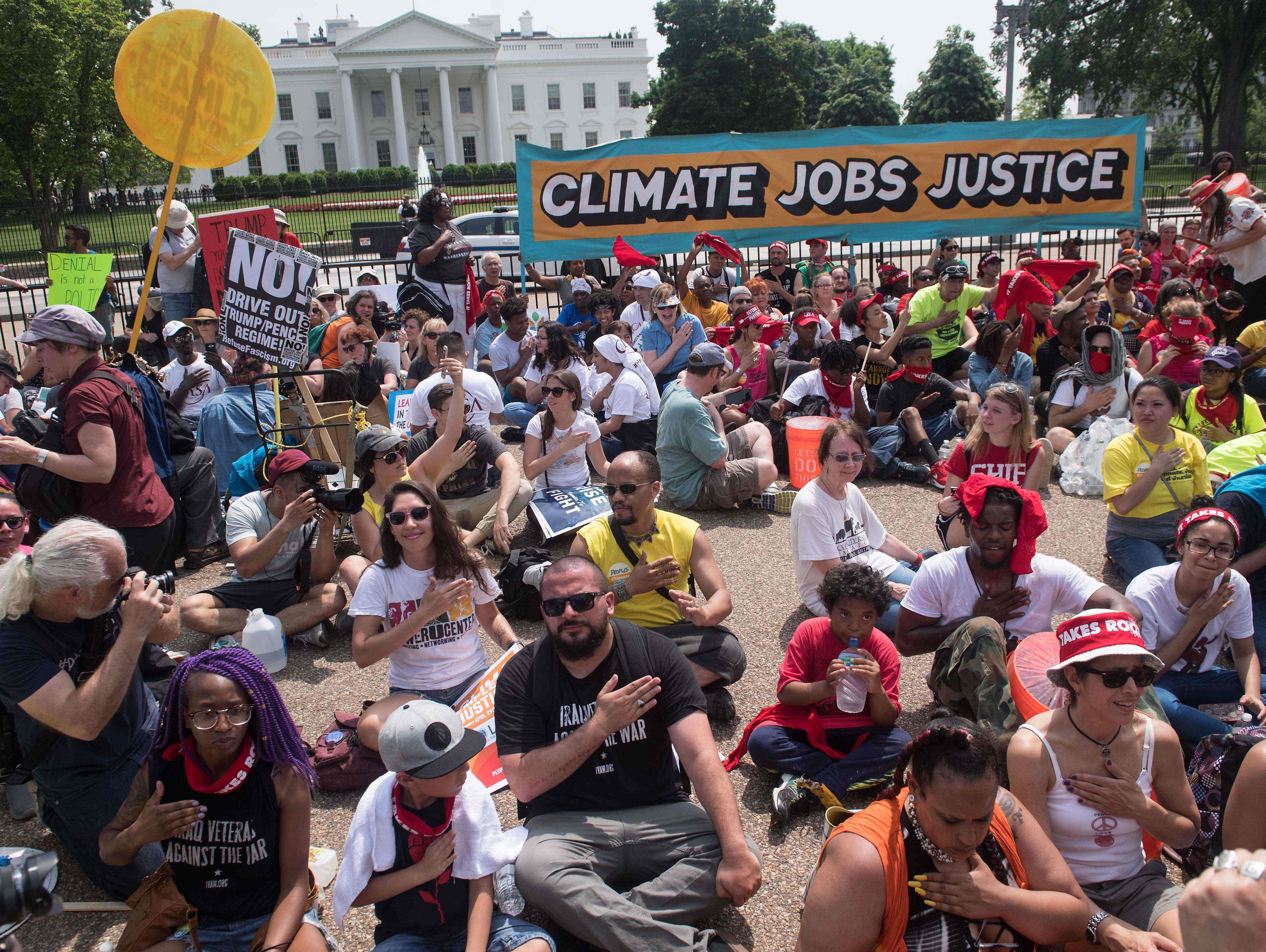 Protesters chant in front of the White House during the People's Climate March in Washington, DC, on April 29, 2017.