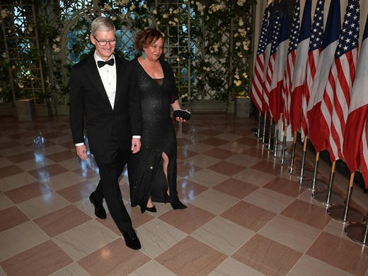 Tim Cook, CEO of Apple, arrives with Lisa Jackson at
