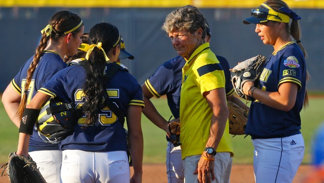 Michigan coach Carol Hutchins, right, talks with starting pitcher Haylie Wagner (17), catcher Lauren Sweet and first baseman Tera Blanco, right, at the pitching circle in the second inning of U-M's 4-1 loss in the final game of Women's College World Series against Florida, Wednesday in Oklahoma City.
