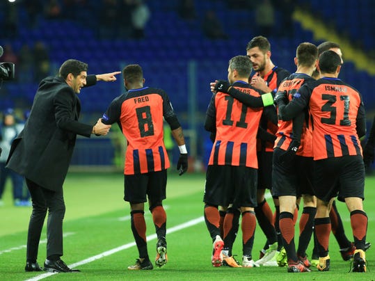 Shakthtar coach Paulo Fonseca, left, shouts instructions to Shakhtar's Fred as other players celebrate their goal during a Champions League Group F soccer match between Feyenoord and Shakhtar Donetsk at the Metalist Stadium in Kharkiv, Ukraine, Wednesday, Nov. 1, 2017. (AP Photo/Sergiy Kozlov)
