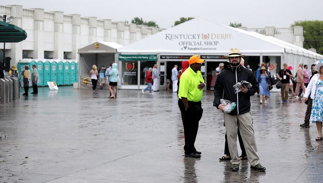 Guests arrive at a wet and rainy Churchill Downs for the 144th running of The Kentucky Derby in Louisville, Kentucky. May 5, 2018