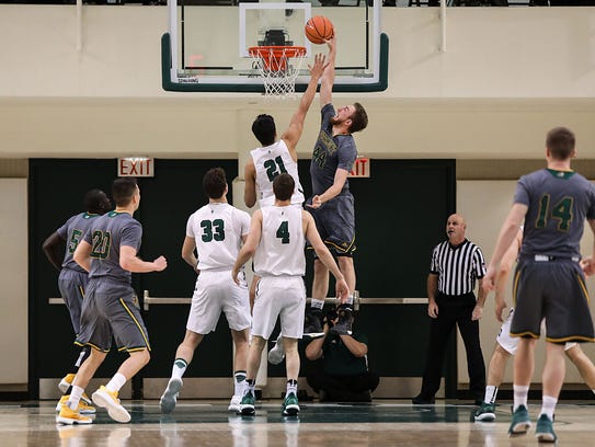 The University of Vermont's Nate Rohrer (44) goes in