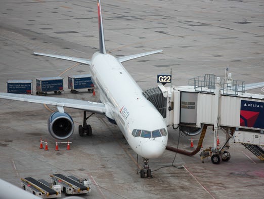 A Delta Air Lines Boeing 757 rests at the gate at Minneapolis