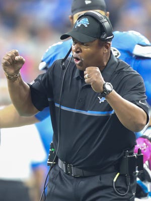 Lions coach Jim Caldwell celebrates a touchdown during the first half of Sunday's win over the Eagles.