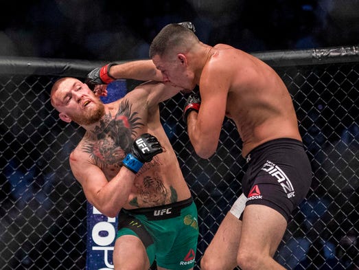 McGregor throws a punch at Nate Diaz in their rematch