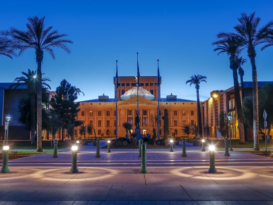 Arizona's State Capitol building lights up at dusk.