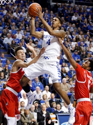 Kentucky's Charles Matthews shoots between Boston University's Nick Havener, left, and Eric Johnson during the first half of an NCAA college basketball game Nov. 24, 2015, in Lexington, Ky.