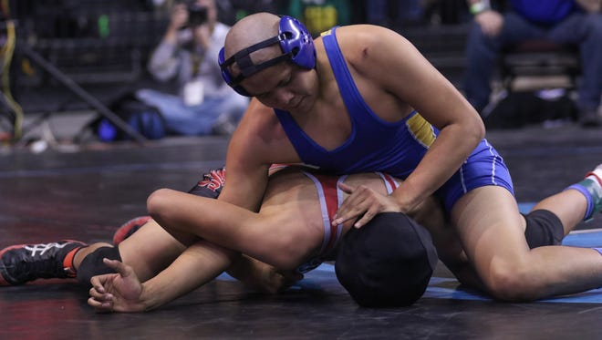 Bloomfield's Jonathan Begaii maintains controls of Shiprock's Latrell Ben in their 145-pound match Friday during the 4A state tournament at the Santa Ana Star Center in Rio Rancho.