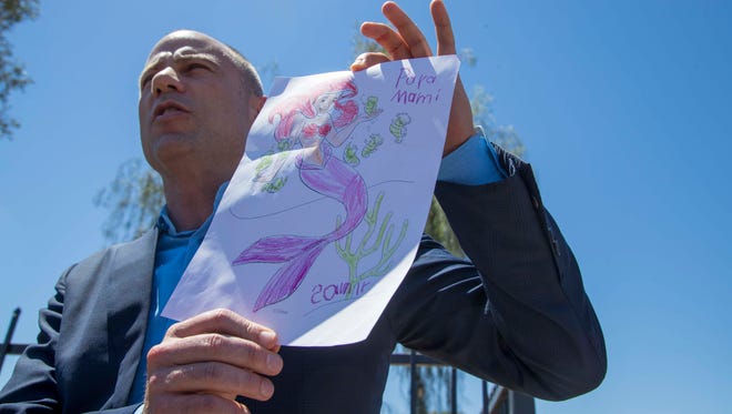 Attorney Michael Avenatti holds a picture colored by 6-year-old Samir from Honduras who has been at the Southwest Key facility near 27th and Campbell avenues in Phoenix for about 10 days. Avenatti says that he gave Samir a letter from his mother, whom he says he is representing in a lawsuit, and that Samir gave him the picture to send to his mother in return.