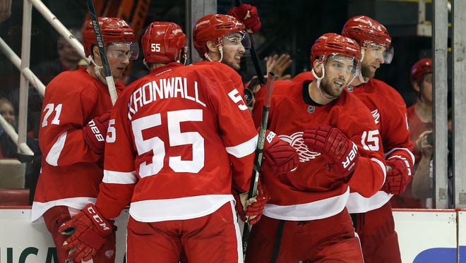 Dec 22, 2015; Detroit, MI, USA; Detroit Red Wings center Riley Sheahan (15) celebrates with his teammates after scoring a third period goal during the game against the New Jersey Devils at Joe Louis Arena. The Devils defeated the Wings 4-3.