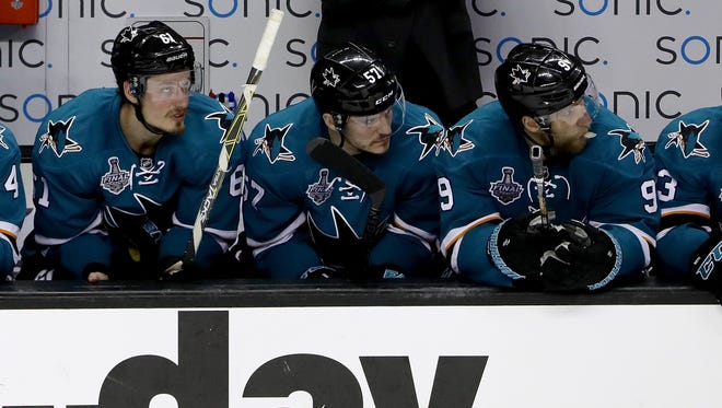 From left, Justin Braun, Tommy Wingels and Dainius Zubrus of the San Jose Sharks sit on the bench in Game 4.