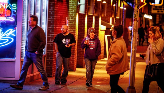 Before a recent Grizzlies game, patrons of Beale Street enjoy a "large beer" as they walk up down the three block area that the City allows open containers of alcohol. Next week, the Memphis City Council could vote to extend the open containers ordnance to include a larger area of Downtown, stretching from the Mississippi River to Danny Thomas Boulevard.