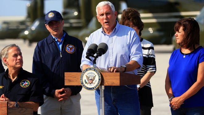 Vice President Mike Pence, center, talks to the media after visiting the Coastal Bend after Hurricane Harvey destroyed several homes Thursday, Aug. 31, 2017, in Corpus Christi, Texas.