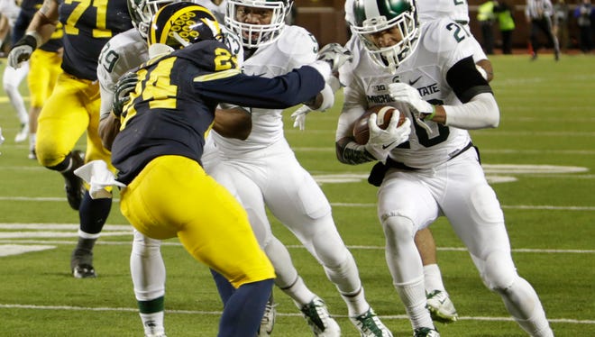 Michigan State's Jalen Watts-Jackson runs the ball down the sidelines for the winning touchdown after he picked up a muffed snap in the last 10 seconds of the game between Michigan and Michigan State in Ann Arbor on Oct. 17, 2015.
