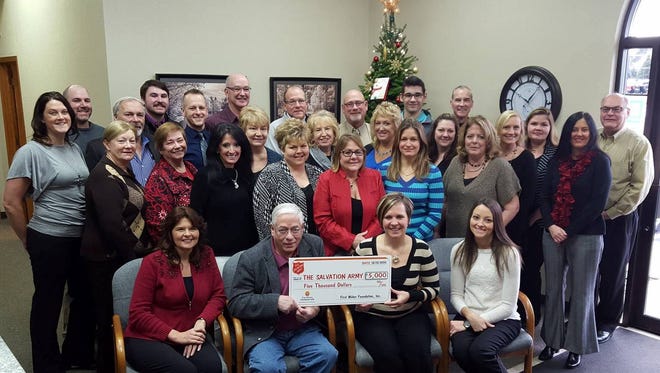 Staff of First Weber Realtors of Stevens Point present a check for $5,000 to The Salvation Army of Portage County.