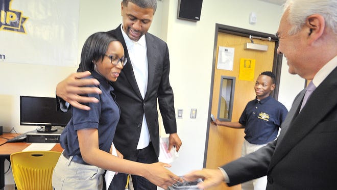 Both Jiyah Pitt, 16, with Jalen Rose and Doug Ross, president of American Promise Schools, and Teion Howard, 16, say new graduation requirements will help prepare them for the challenges of college.