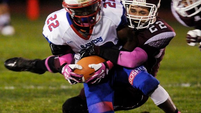 Goshen High School's Deondrade Well is tackled by New Paltz's Avery Sells on Friday in New Paltz.