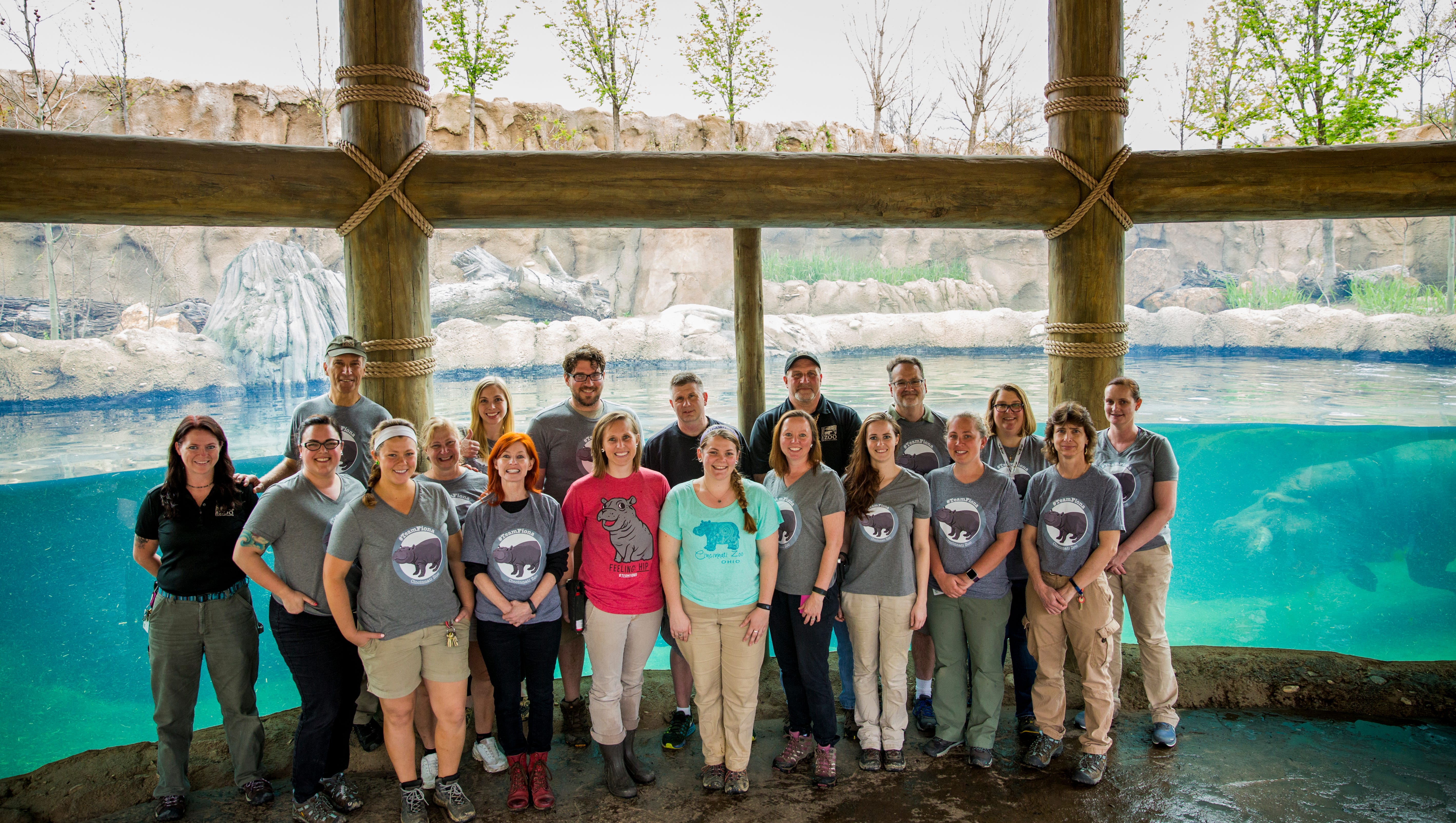 Members of Team Fiona pose for a portrait in the Hippo Cove at the Cincinnati Zoo & Botanical Garden Tuesday, April 11, 2017. Front Row from left to right: Jen Meeks (Dive Team), Christina Gorsuch (Coach of #TeamFiona and Curator of Mammals), Jenna Wingate (Africa Keeper), Michelle Curley (Communications Director), Wendy Rice (Africa Head Keeper), Alexandra Zimmer (Africa Keeper), Tami Ware (Africa Keeper), Lauren Huber (Africa Keeper), Amy Long (Vet Team), Jenny Kroll (Vet Team)    Second Row from left to right: Thane Maynard (Zoo Director), Dawn Strasser (Neonate Keeper), Michelle Kuchle (Neonate Keeper), Dan Turoczi (Africa Keeper),  Dr. Greg Levens (Veterinarian),  Bob Lessnau (Director of Animal Collections), Dr. Mark Campbell (Director of Animal Health), Barbara Henry (Nutritionist), Dana Burke (Africa Team Leader)    Not pictured: Teresa Truesdale (Africa Keeper and overnight person for Fiona), Angela Hatke (Communications Coordinator), Jenny Nollman (Veterinarian), Natalie Holthaus  (Africa Keeper), Dr. Jessye Wojtusik (Reproductive Physiologist)   