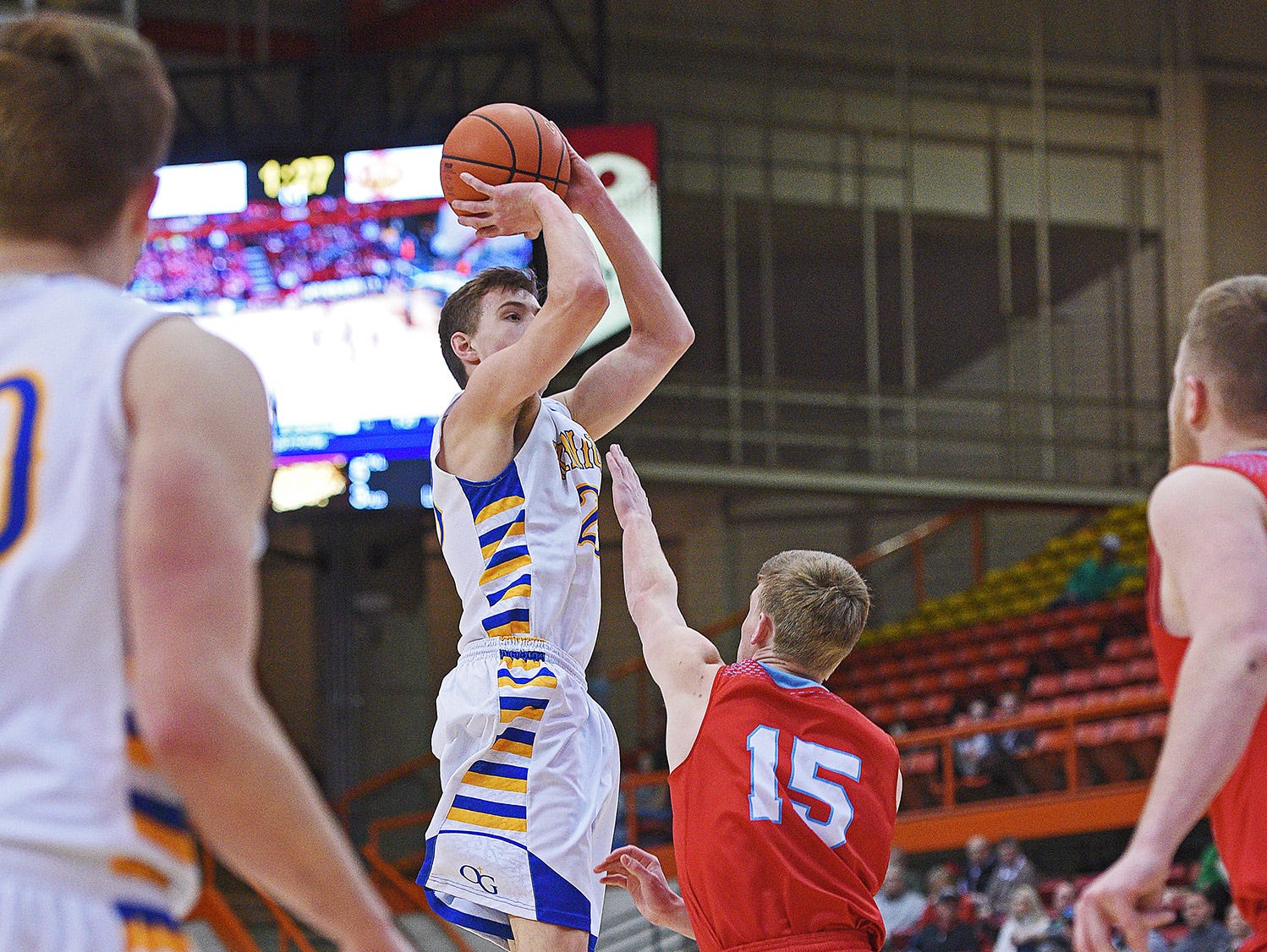 O'Gorman's Matt Cartwright (23) goes up for a shot over Lincoln's Alex Glanzer (15) during a 2017 SDHSAA Class AA State Boys Basketball semifinal game Friday, March 17, 2017, at Rushmore Plaza Civic Center in Rapid City.