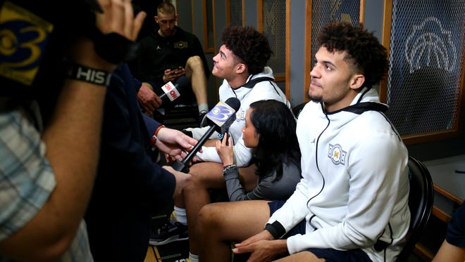 Michigan guard Jordan Poole, left, and forward Isaiah Livers (4) speak with members of the media in the locker room on Sunday, April 1, 2018, at the Alamodome in San Antonio.