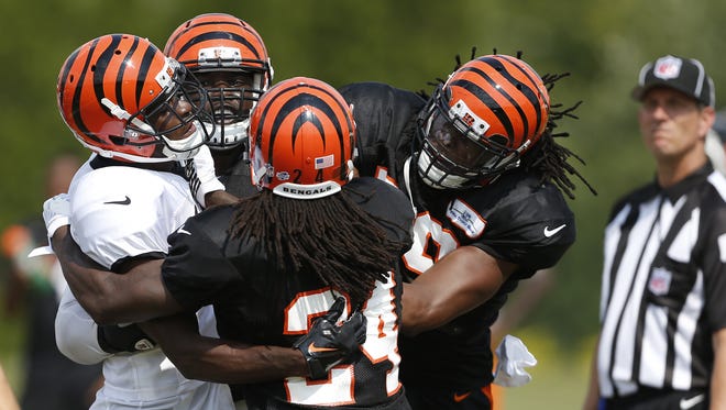 Cincinnati Bengals linebacker Emmanuel Lamur, right takes a swing at wide receiver A.J. Green during an on field argument at training camp downtown.