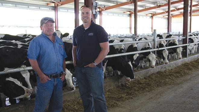 Lancaster farmer Ron Abing (left) and Joe Schmeltz, NRCS Grant County District Conservationist, view a new freestall barn for heifers on Abing's farm Majestic View Dairies, LLC,