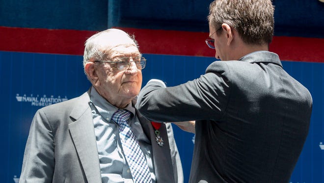 World War II veteran Edwin Stewart, 93, of the United States Army Air Forces, left, is awarded the French Legion of Honor by Clément Leclerc, Consul General of France in Miami, at the National Naval Aviation Museum on Wednesday, June 13, 2018. The Legion of Honor is France's highest award for military and civil merits and Stewart received the award in the rank of Knight for his role in liberating France and Europe.
