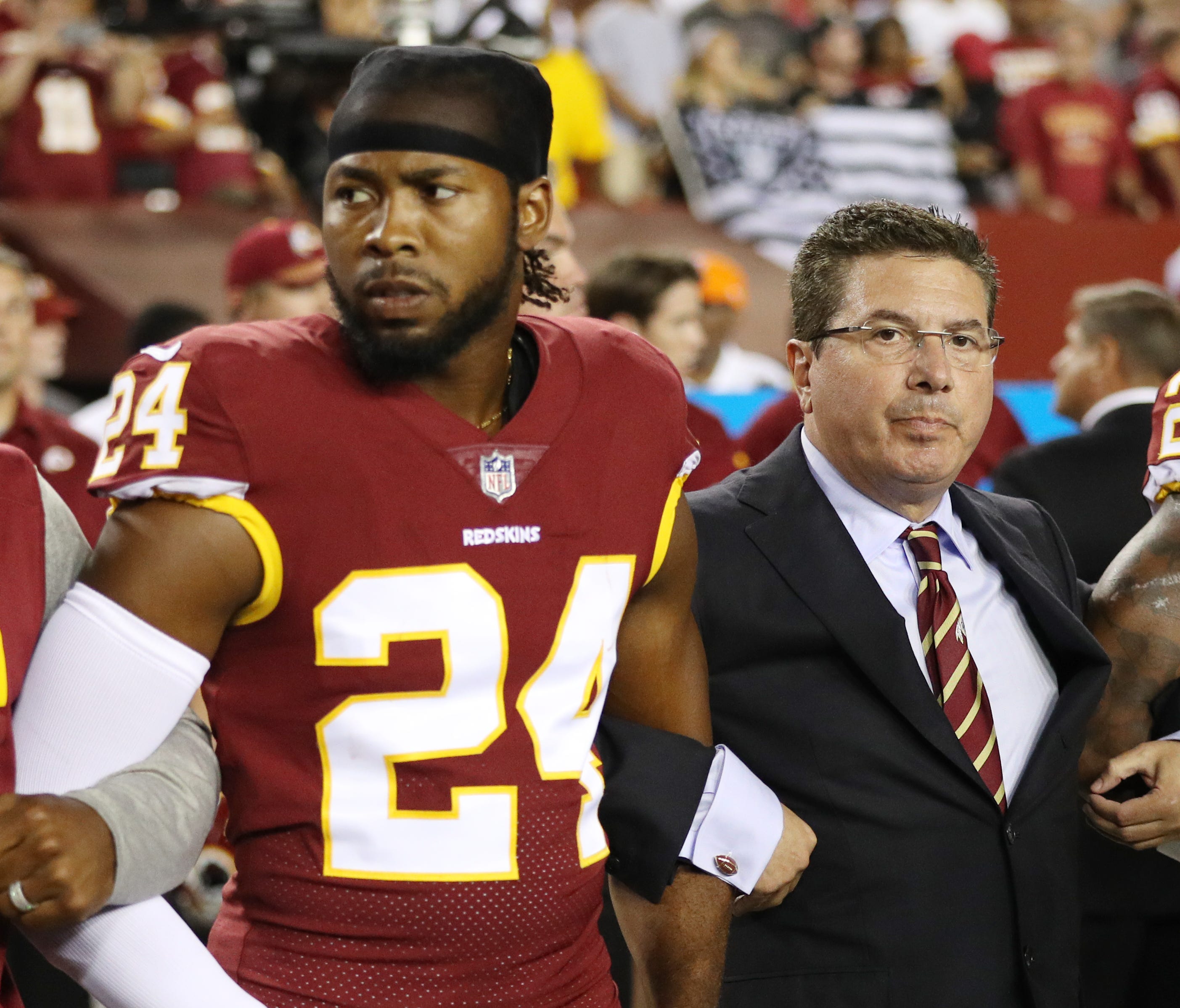 Washington Redskins owner Daniel Synder stands with cornerback Josh Norman during the the national anthem before the game against the Oakland Raiders at FedExField on September 24, 2017 in Landover, Maryland.