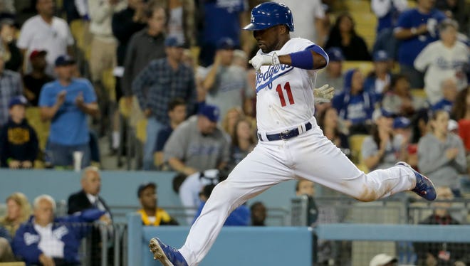 The Dodgers' Jimmy Rollins scores on a double by Joc Pederson during the seventh inning Monday night.