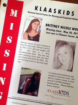 This Oct. 21, 2014, photo shows a flier about missing teenager Brittney Wood at her stepmother's home in Mobile, Ala. The teen hasn't been seen since May 2012 and is presumed dead, but 11 relatives and family friends have since been arrested as members of an alleged ring that swapped children for sex. Authorities say Wood could have been a key witness. (AP Photo/Jay Reeves)
