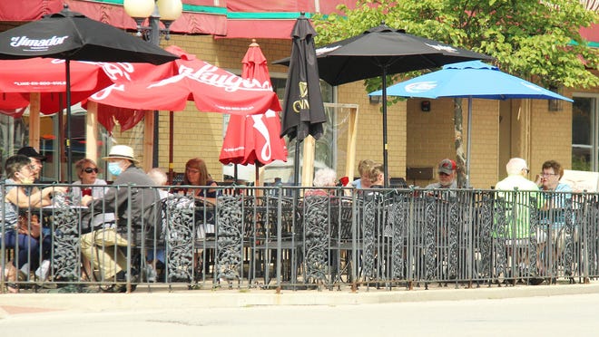 Patrons gather for lunch at DeLong's Casual Dining Wednesday afternoon. Although getting cooler, the weather is still conducive to outdoor dining.