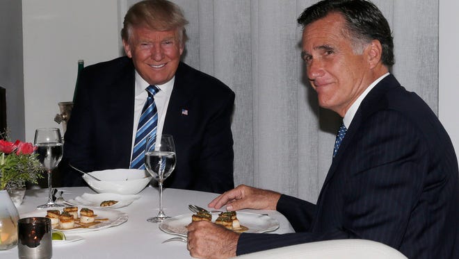 President-elect Donald Trump sits at a table with former governor of Massachusetts Mitt Romney at Jean Georges Restaurant in New York City, Nov. 29, 2016.