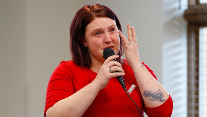 Domestic abuse survivor Alesha Meyers chokes up as she talks about violence in her past at a panel on how to spot domestic abuse warning signs, Wednesday at the public library in Wausau.