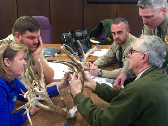 The TWRA's Eric Anderson, middle, tallies the measurements