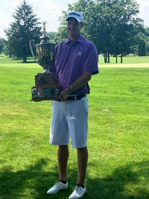 Chase Wilson, of Zanesville, poses with the trophy after winning the 97th Ohio Open on Wednesday at Weymouth Country Club in Medina. Wilson, who finished at 14-under-par, became the first Muskingum County resident to win the event.