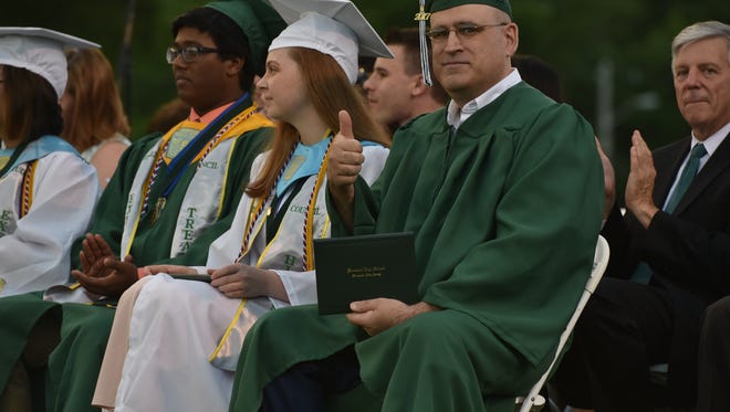 Sgt. Robert Dollaway gives a thumb up after receiving his diploma from Kinnelon HS.