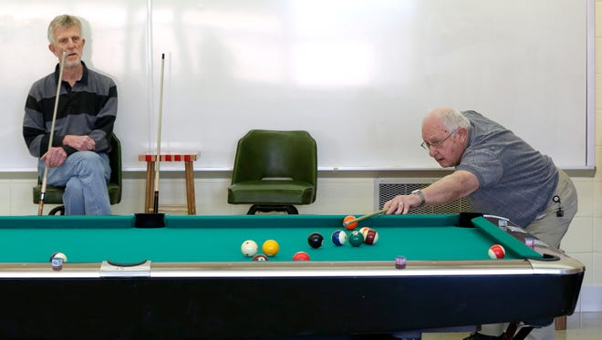 Ray Zuelke, left, of Combined Locks and Ray Lake of Grand Chute play a game of pool Monday, April 11, 2016, at St. Bernadette in Appleton.