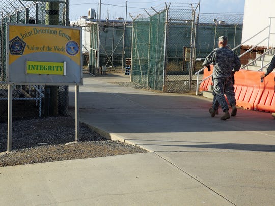 Military personnel walk near the U.S. detention center