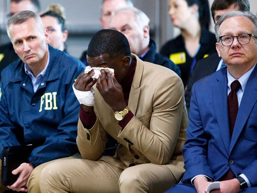 Hero James Shaw wipes tears away during a press conference