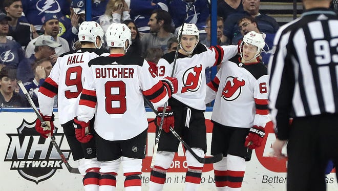 New Jersey Devils center Nico Hischier (13) is congratulated by teammates as he scores a goal against the Tampa Bay Lightning during the second period at Amalie Arena on Saturday, Feb. 17, 2018.