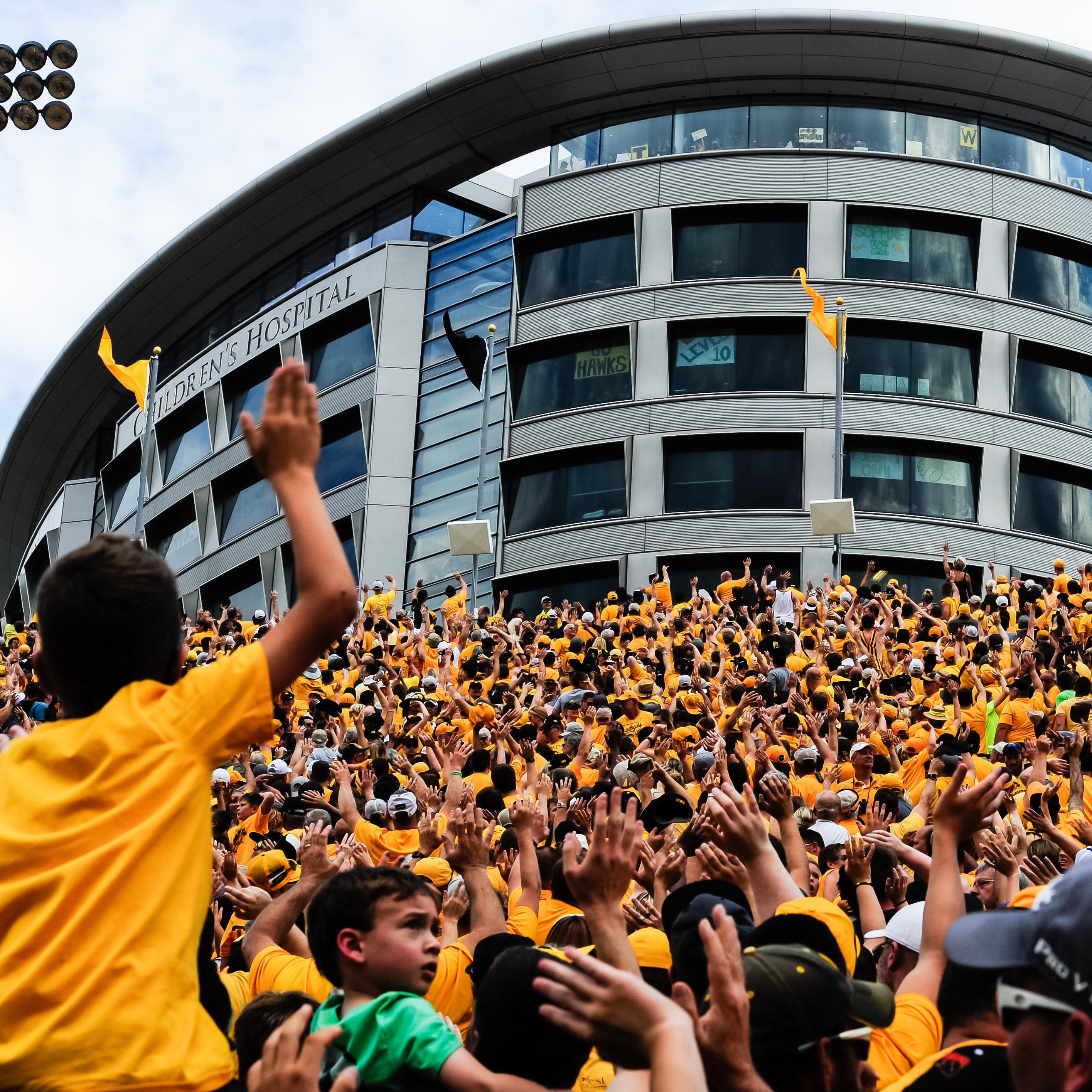 Iowa fans wave to the Children's Hospital at the end of the first quarter during a recent game against North Texas.