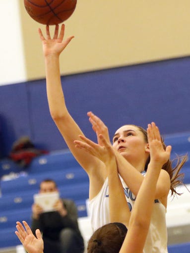 Brookfield Central's Anna Mortag shoots over Menomonee