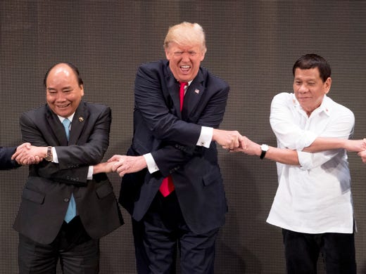 President Trump, center, reacts as he does the "ASEAN-way
